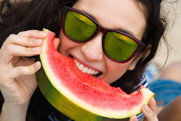 istock Funny girl eating watermelon 530989316
