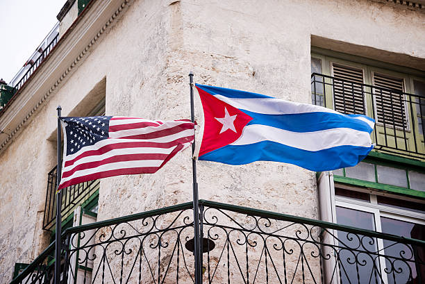 us and cuban flags side by side in havana, cuba - 古巴 個照片及圖片檔