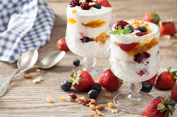istock Yogurt with fruits on wooden table 530993944