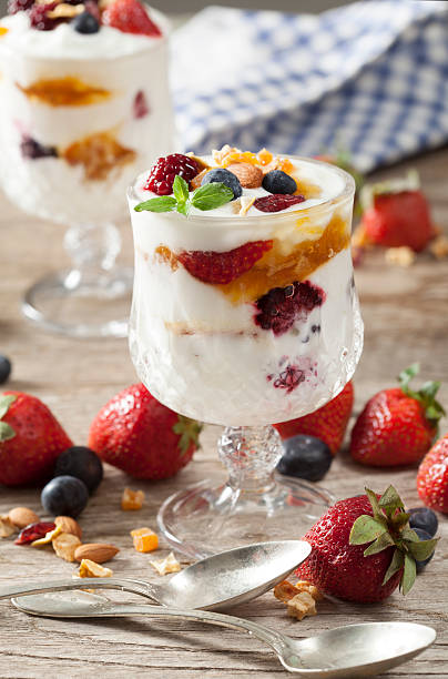 istock Yogurt with fruits on wooden table 530994018