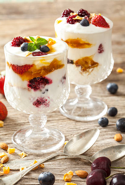 istock Yogurt with fruits on wooden table 530994330
