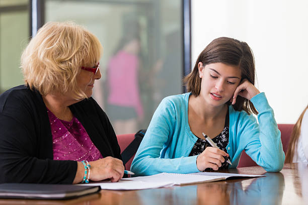 istock Junior high school student taking placement test with teacher 530995835