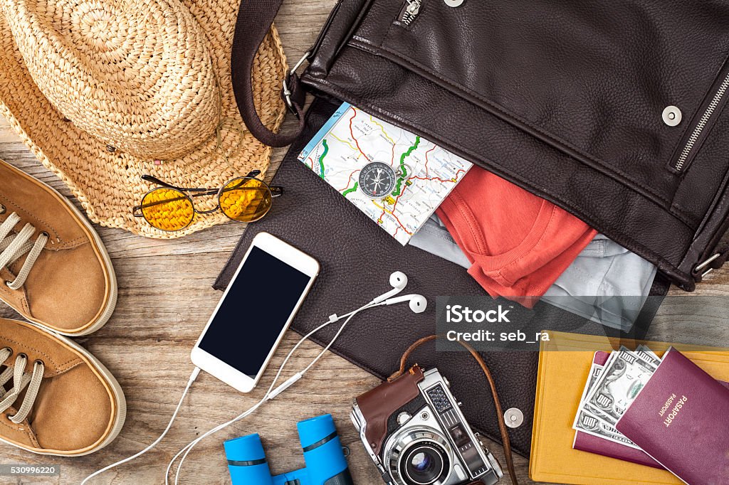 Holiday suitcase on wooden table Travel Stock Photo