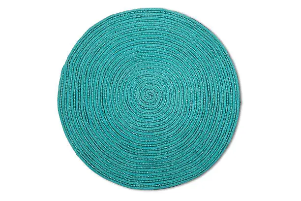 Turquoise spiral woven place mat with clipping path.