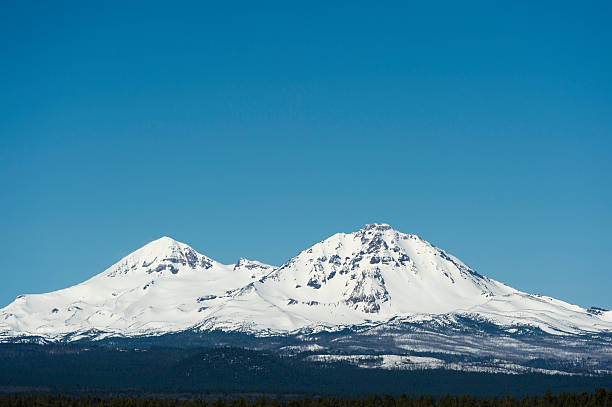 istock Three Sisters Mountains Oregon with Snow and Blue Sky 530997752