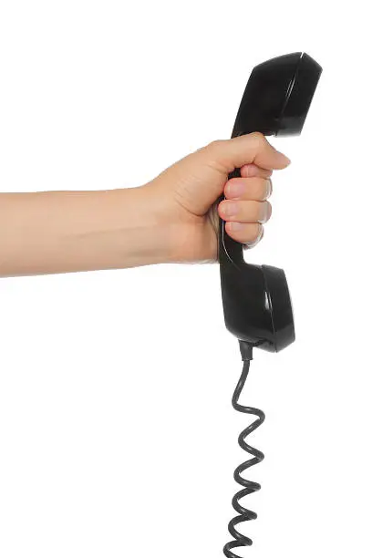 Hand holds retro telephone tube on white background