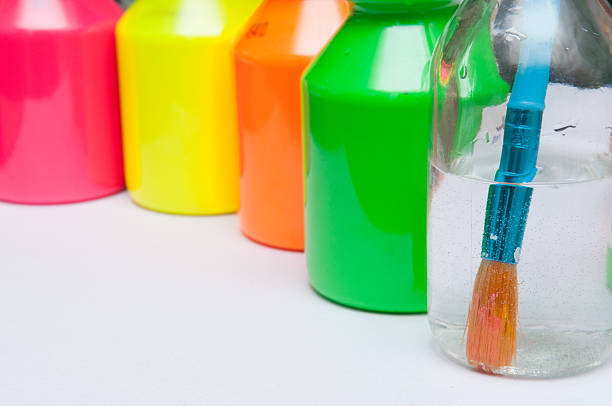 istock Bright colored paint pots with paint brush for childrens art 530998922