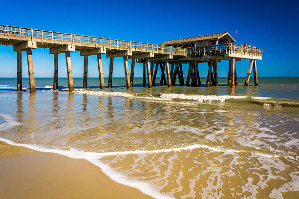 The fishing pier and Atlantic Ocean at Tybee Island, Georgia. The fishing pier and Atlantic Ocean at Tybee Island, Georgia. tybee island, georgia stock pictures, royalty-free photos & images