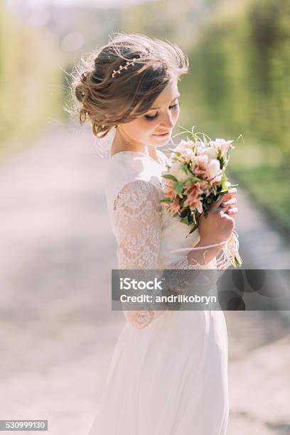 Beautiful Blonde Bride With Bouquet Of Spring Flowers Outdoor Stock Photo - Download Image Now