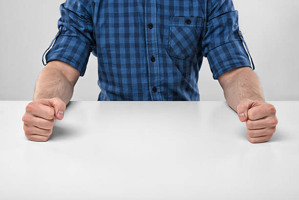 istock Closeup masculine fists clenched on the table 531000218