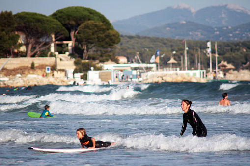La Ciotat, France - September  11, 2015: Mother teaches child to surf on the beach