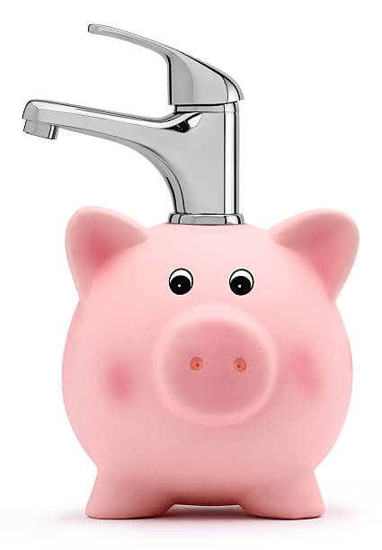 istock piggy bank with tap water saving concept 531000815