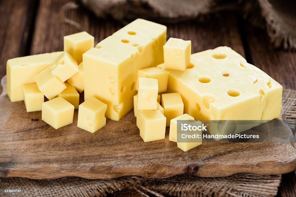 Block of Cheese Block of Cheese (close-up shot) on vintage wooden background 2015 Stock Photo