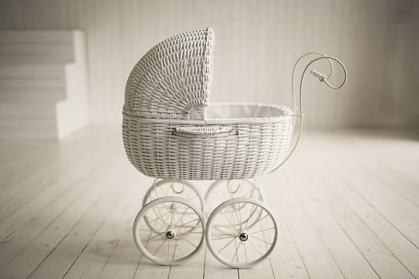 Beautiful old fashioned white pram in white room stock photo