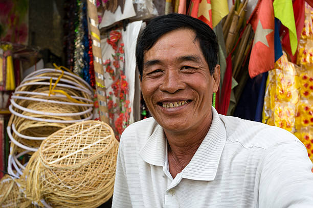 Ho Chi Minh City, Vietnam - January 9, 2016: Portrait of a Vietnamese market vendor at Binh Tay Market located in the Cholon area of Ho Chi Minh City, Vietnam.