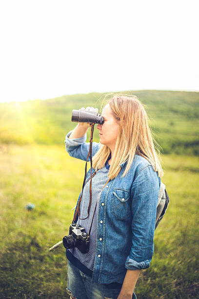 istock woman traveler looking through binoculars 531002514