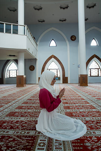 istock Young muslim woman praying in mosque 531003280