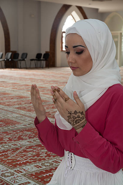 istock Young muslim woman praying in mosque 531003968