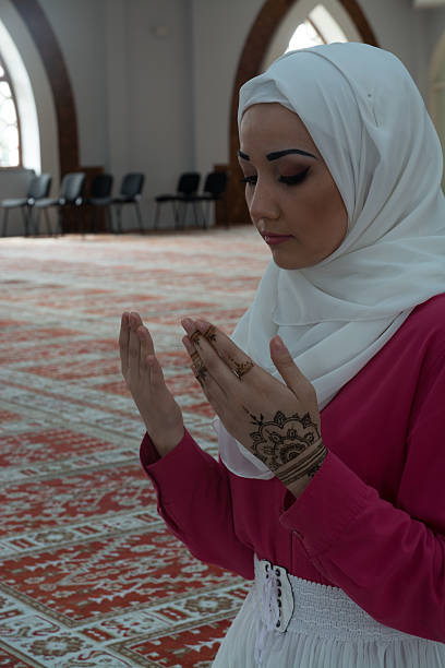 istock Young muslim woman praying in mosque 531004050