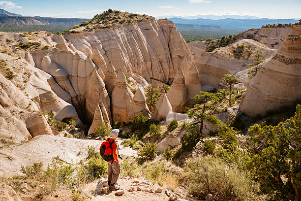 Hiking New Mexico Backpacker hiking at Kasha-Katuwe Tent Rocks National Monument in New Mexico. USA. kasha katuwe tent rocks stock pictures, royalty-free photos & images