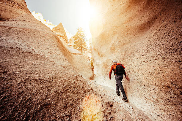 Hiking New Mexico Backpacker hiking at Kasha-Katuwe Tent Rocks National Monument in New Mexico. USA. kasha katuwe tent rocks stock pictures, royalty-free photos & images