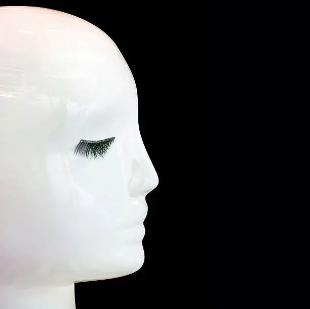 Closeup white female mannequin head-profile, isolated on black square background clipping path and copy space included, full frame square composition