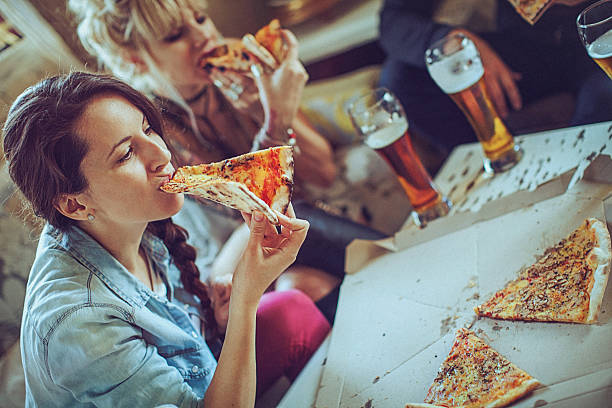 istock Friends enjoying time eating pizza and drinking beer together 531005760