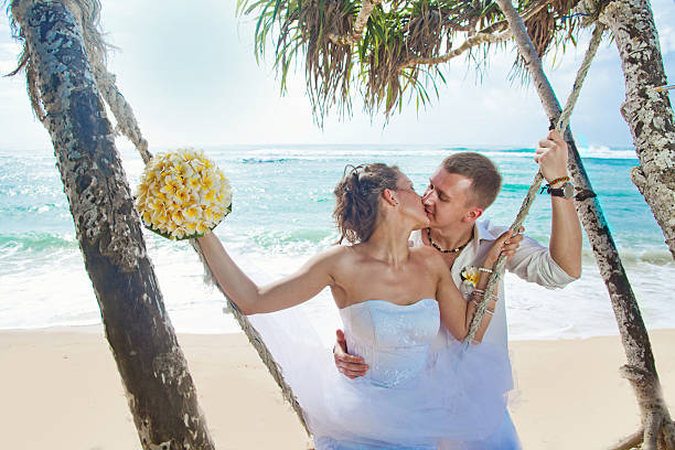 istock Bride and groom kissing on the beach 531011603