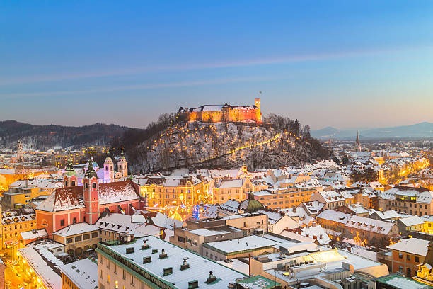 Panorama of Ljubljana in winter. Slovenia, Europe. Aerial panoramic view of Ljubljana decorated for Christmas holidays. Roofs covered in snow in winter time. Slovenia, Europe. ljubljana castle stock pictures, royalty-free photos & images