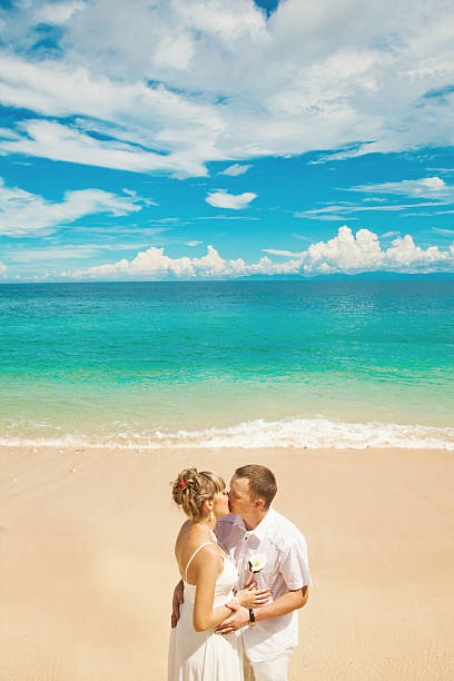 istock Bride and groom kissing on the beach 531012983
