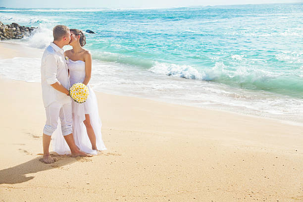 istock Bride and groom kissing on the beach 531014029