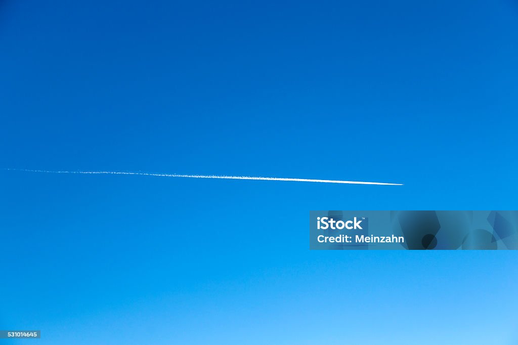 plane flying on a perfectly blue sky with Vapor Trail A plane flying on a perfectly blue sky with Vapor Trail Air Vehicle Stock Photo