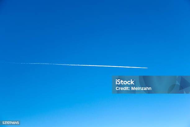 Plane Flying On A Perfectly Blue Sky With Vapor Trail Stock Photo - Download Image Now