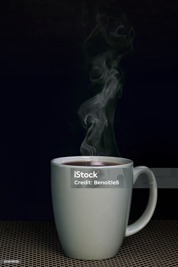 Warm Coffee Warm coffee mug in front of black background 2015 Stock Photo