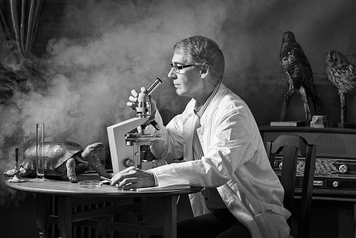 ironically nostalgic image of the scientist who sits with his microscope in smoke and fumes from his experiments