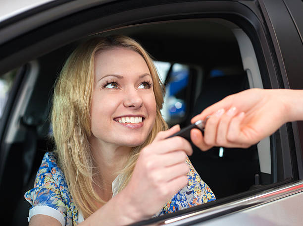 istock Happy smiling woman with car key in car 531020321
