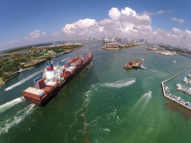 Caargo ship enters port aerial view stock photo