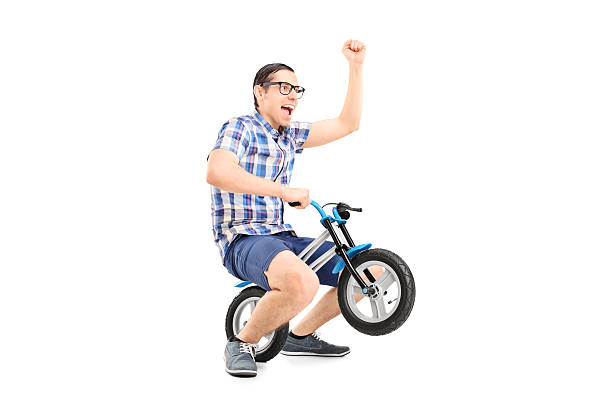 istock Crazy young man riding a small bike 531022861