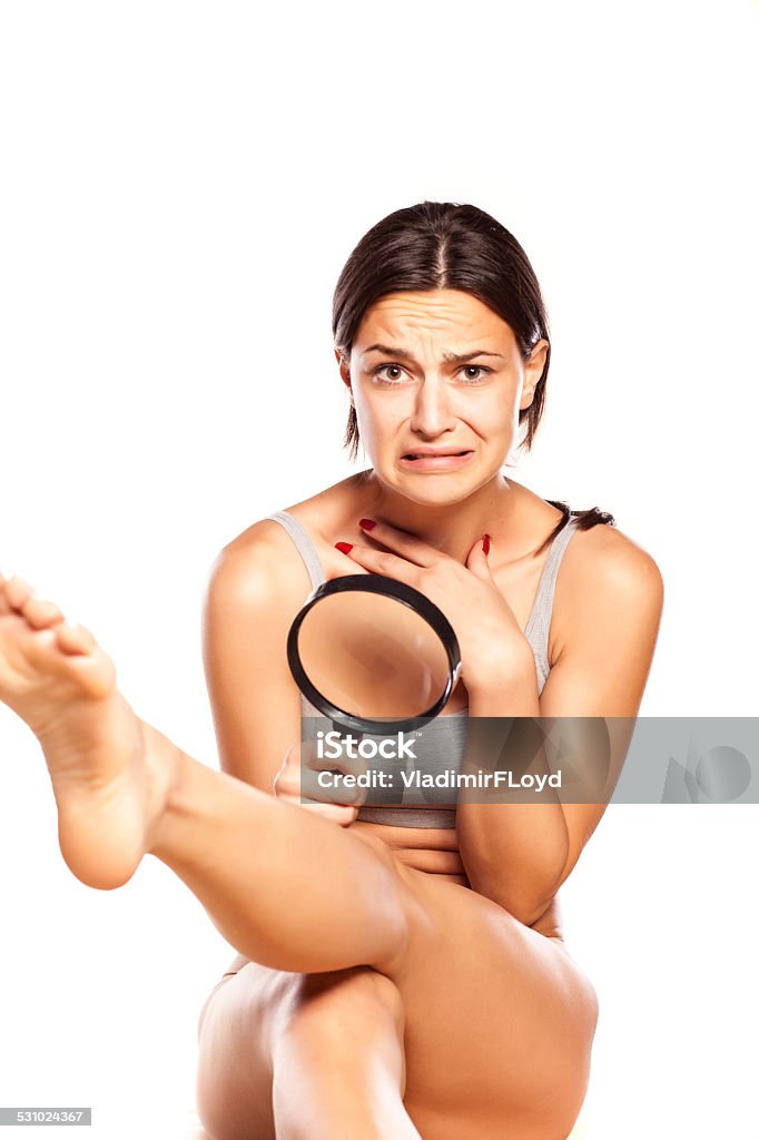 Disgusted girl looking at hair on her legs disgusted girl looking at hair on her legs 2015 Stock Photo