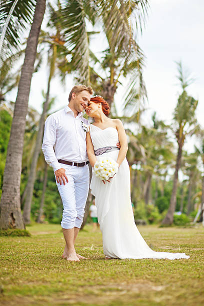 istock Groom and his bride in a tropical park 531035459