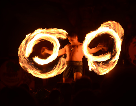 Lahaina, USA - March 22, 2014: Traditional Polynesian dancer performs fire dance during street festivities in Lahaina, Maui on March 22, 2014
