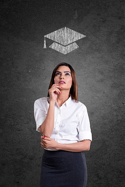 istock College student looking at mortarboard drawn over her head 531043712