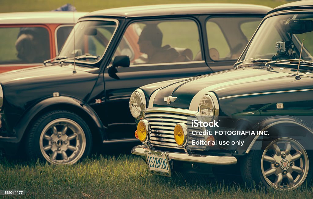 Mini Cooper Classics Oshawa, Ontario, Canada- June 14, 2014. Classic  Mini Cooper cars, at the local vintage car show, parked on the public lawn  at Oshawa suburbs near Toronto, Ontario.  These are original vintage cars of different age and various versions, produced over last 50 years. One of the original small cars, started in UK, Mini has been around since 1959 and has been owned and issued by various car manufacturers. 2015 Stock Photo