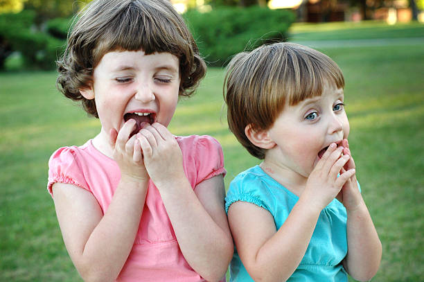 istock Two Little Sisters Laughing Together Outside 531044835