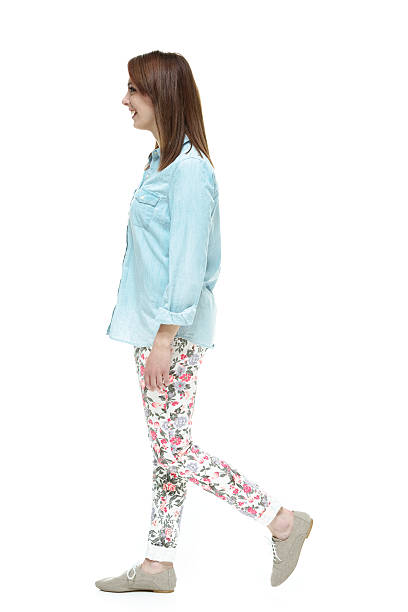 istock Side view of young woman walking 531046381