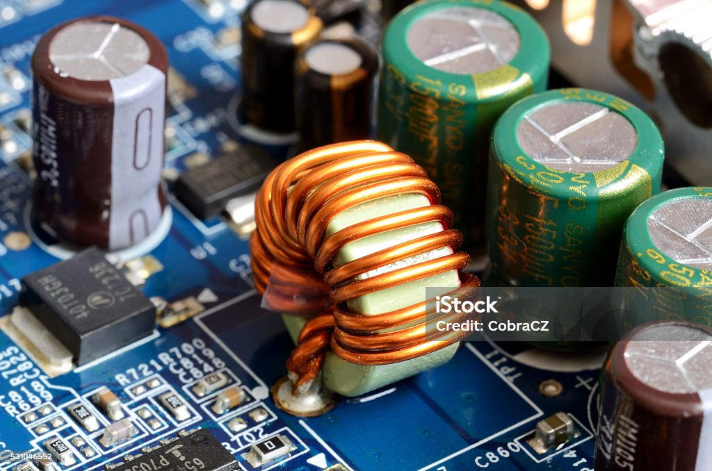 Close-up of inductors, capacitors and chips Detail of graphics card - inductors, capacitors and chips Circuit Board Stock Photo