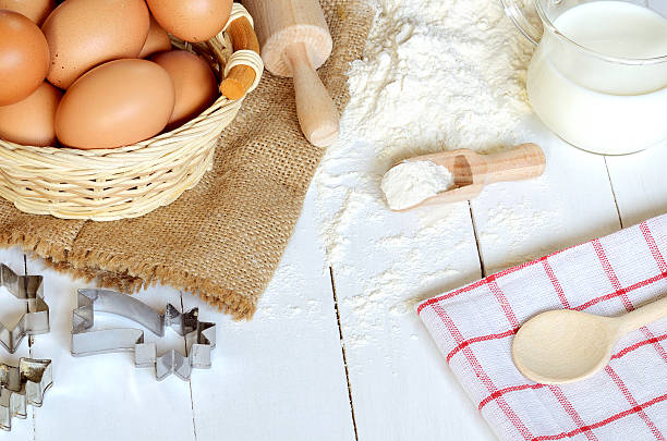 istock Eggs, flour, milk, butter, wooden spoon and cake molds 531046638