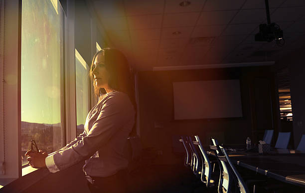 istock CEO woman looking out board room 531046826