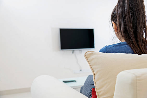 istock asian woman watching TV 531047577