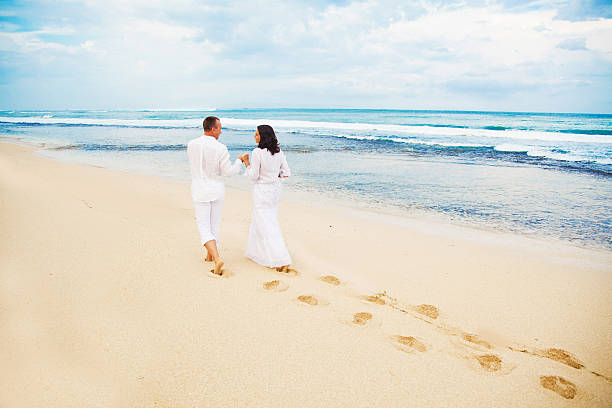 Bride and groom walking on the beach Bali malay couple full body stock pictures, royalty-free photos & images